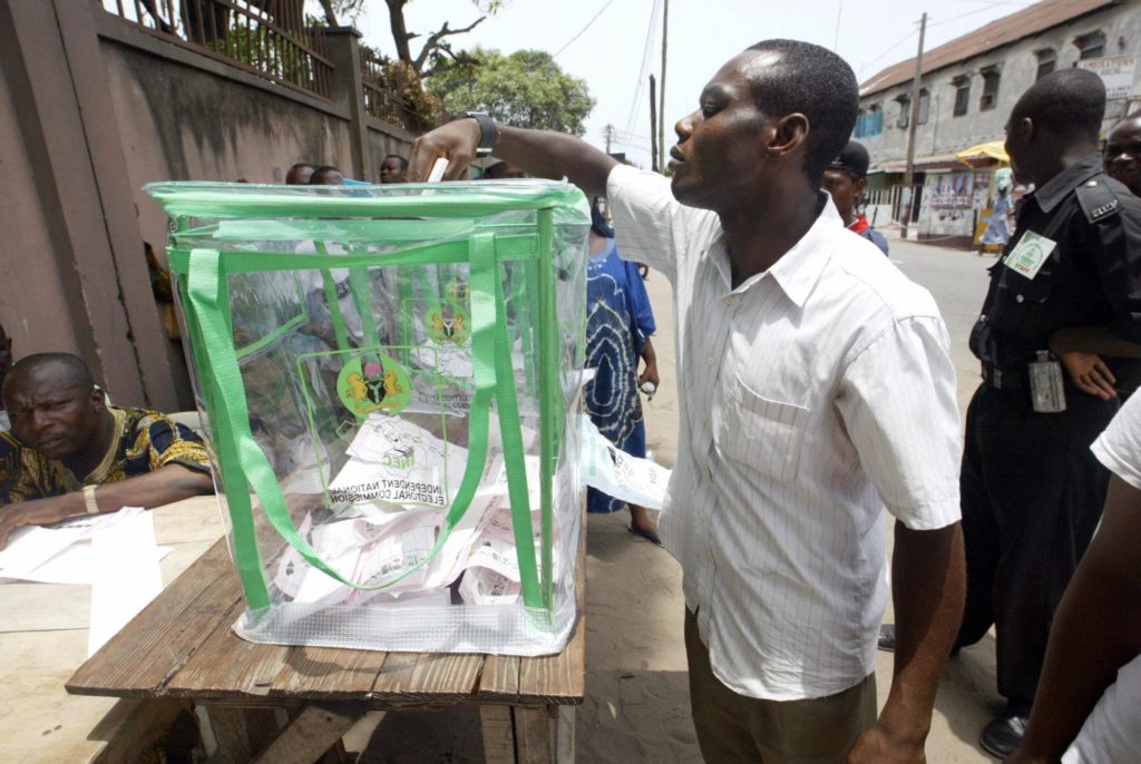 A Man Drops His Voters Card In A Ballot